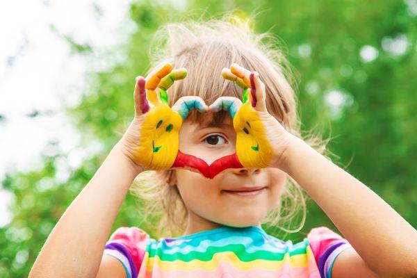 young child with painted hands