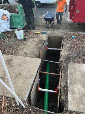 New sewer lateral pipe being installed under the sidewalk, the pipe is 6 inch in diameter