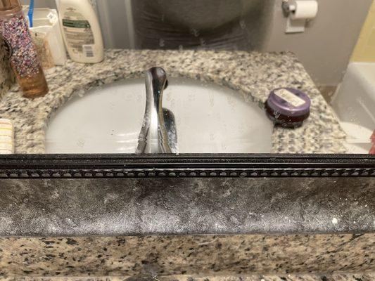 The splashes on the mirror from people brushing their teeth and spitting in the sink.