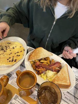 Chocolate chip pancake, toast, eggs, home fries, coffee