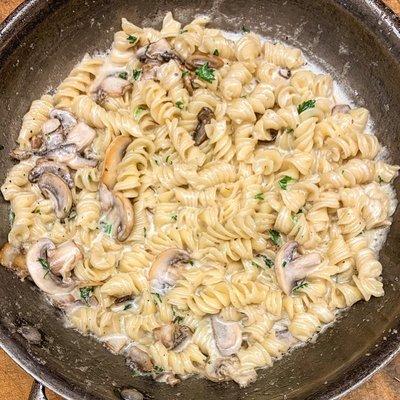 Fusilli with a white cream sauce and mushrooms.