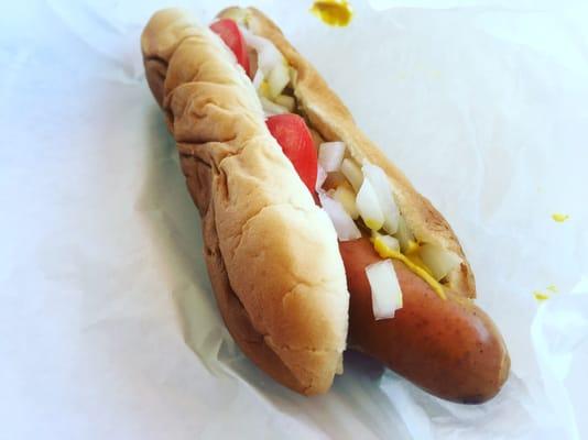 Casper dog with mustard, tomato, and onions.