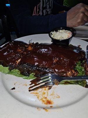 Burned ribs covered with BBQ sauce so we don't notice the burned meat