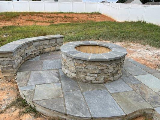 Blue stone wall and firepit by Total Masonry