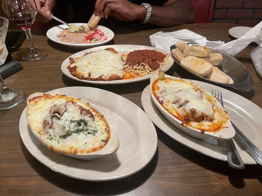 Eggplant parm on the left, lasagna on the right, veal parm in the middle next to the breadsticks