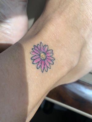 Pink daisy on right ankle.