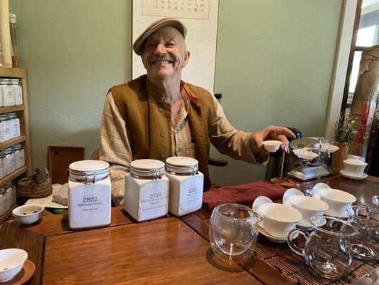 David Lee Hoffman serving a flight of green tea at his tea table at the Tea Museum.