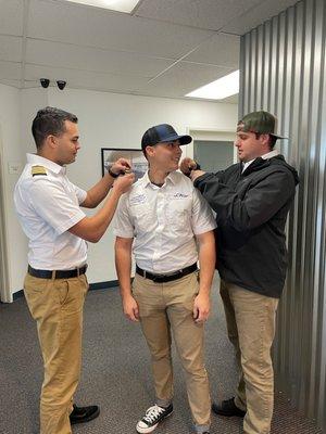 CAU San Diego student receiving his epaulettes after passing his flight checkride