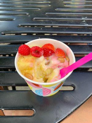 Strawberry & Cheesecake swirl w/ Mango & Pineapple swirl frozen yogurt topped with fresh raspberries, strawberries, pineapples & peanuts.