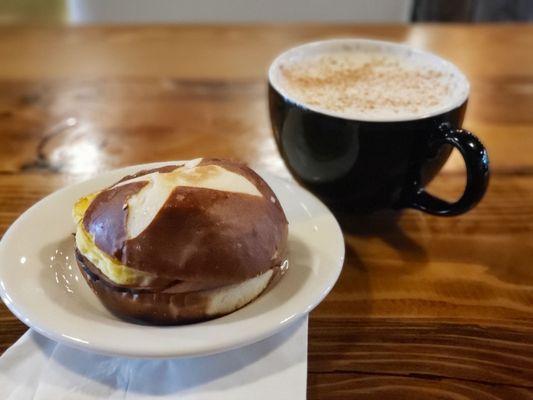 Bavarian ham, egg & cheese on pretzel bread and chai latte.