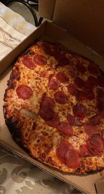 Burnt pepperoni pizza.