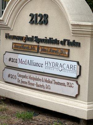 Sign out front of HydraCare's location in Tulsa showing you the Suite number of 202