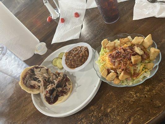 Pulled pork sandwich with baked beans and a salad.  It's good