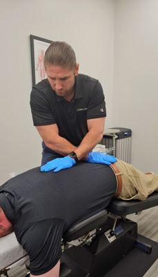 Dr John Maloney, DC - Chiropractor using flexion distraction table for low back pain