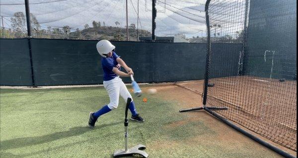 Youth player taking some extra swings