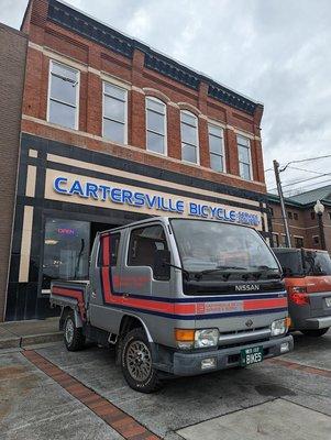 Our 29 year old shop truck in front of our 135 year old building.