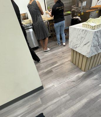 Employee is wearing a dress and is in open toed shoes.