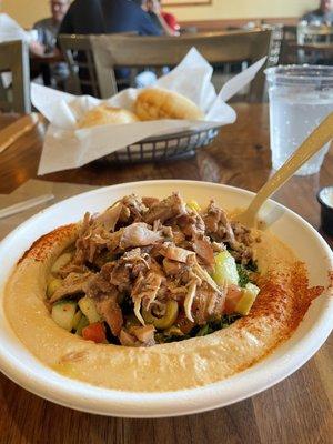 Chicken Shawarma Bowl with Spicy Hummus, tabbouleh, and village salad.