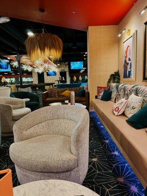 Indoor lounge seating with duck bowling lanes in the background