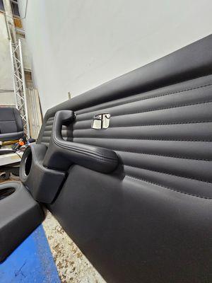 1992 BMW E30 door panels, speaker pods, and armrest/handle redone in black.