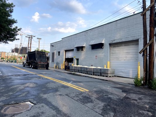 Every morning at 7am, a dumpster truck arrives to lift and shake large bins to discard tofu from next door. This is extremely noisy.