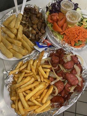 Sirloin steak tips and Frida Yuka, and brazilian kielbasa and fries, with salad.