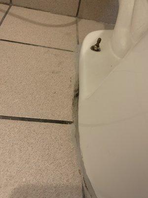 Leaking toliet and grimy dirty floor