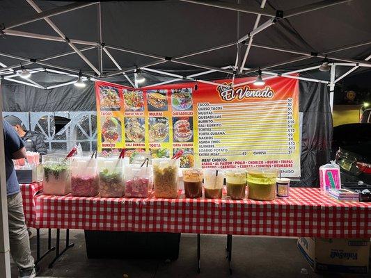 Menu and buffet of salsas & vegetables.