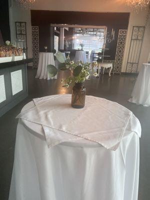 Rehearsal dinner center pieces repurposed in bar area for reception.