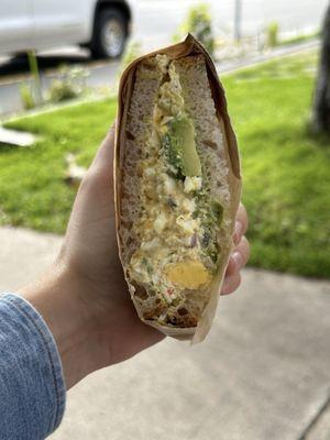 Messy egg salad avocado sandwich