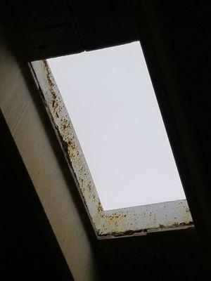 Skylights over the pool have rust and chipped paint