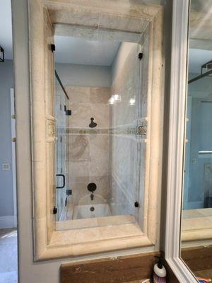 Stunning frameless stationary window really completes the bathroom remodel.