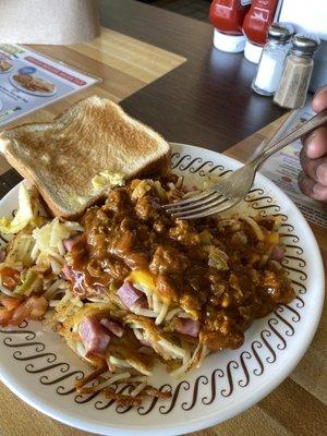 Hash browns scattered smothered covered chunked with a lil bit of chili egg scrambled on the side