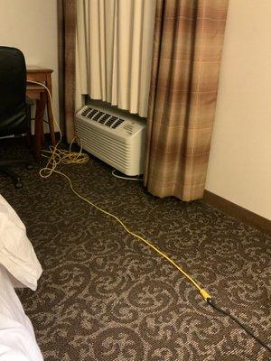 The utility power cord provided by the staff to get electricity to the bedside lamp and my CPAP machine.