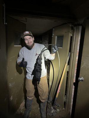 Josh removing wipes from a main sewer clog