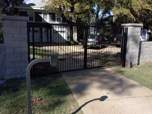 Iron gate, Three inch post, two electric gate operators, one numeric key pad.