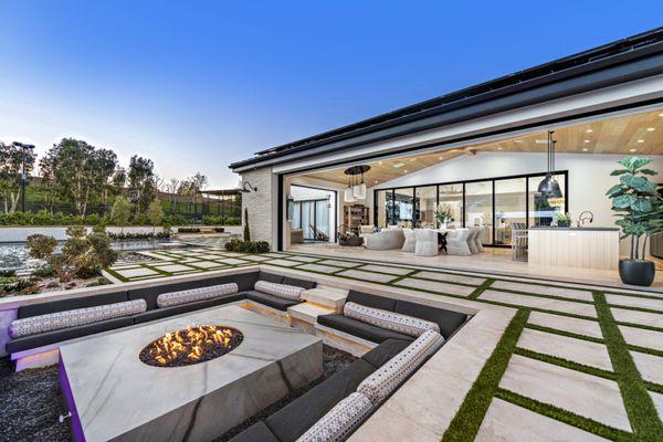 Sunken fire pit, custom turf inlay decking, California room