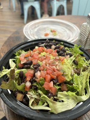 Bowl with chicken, beans, corn, veggies and a tiny bit of guacamole salsa and pico and rice. Not a very big bowl.