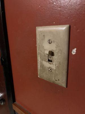 Disgusting light switch. I guess I won't be conserving energy today. In bathroom.