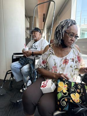 Mom eating chic fil a and dad pretending that he needs a wheel chair