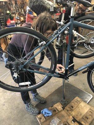 Bike Church Master Mechanic helps with a bike repair.