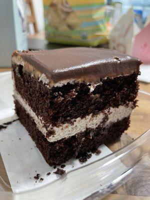 Creme cookie ganache cake slice.