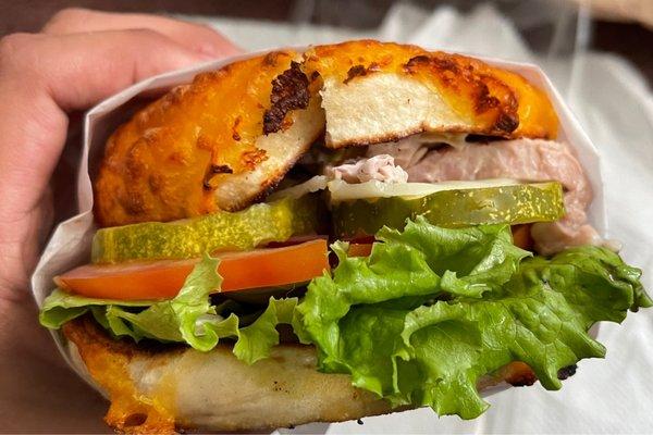 Hot turkey specialty sandwich (bagel) with a cheese bagel.