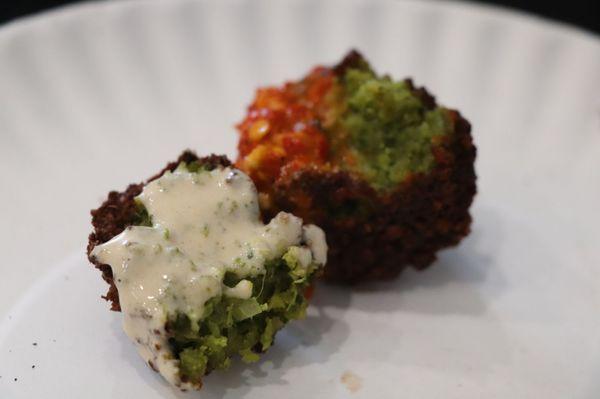 Fluffy delicious falafel ... One with tahini sauce and one with spicy red sauce.