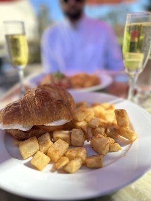 Tour Effiel Croissant Sandwich with a side of potatoes