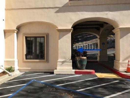 Patient entrance under bridge on lower level through elevator lobby