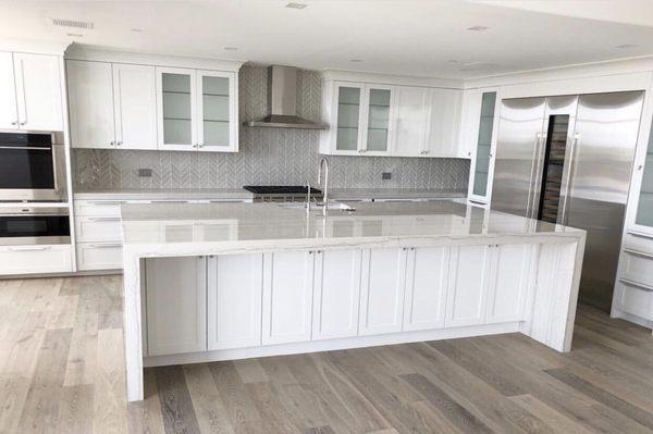 Quartzite waterfall island & tile backsplash.