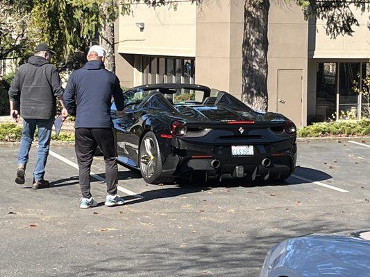 Sound Wheel Alignment, he's inspecting and talking to the customer about his Ferrari $299,000