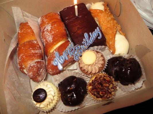 Cannoli donuts, ganache, cannoli, cannoli cream puffs and assorted mini cheesecakes.