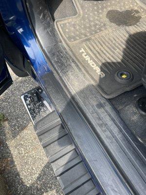 Dirt Visible on Floor Matt, Door Bottom, and Wax residue not removed from Running Board.